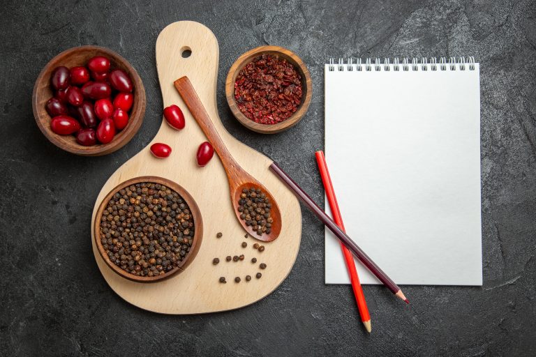 top-view-fresh-red-dogwoods-with-seasonings-dark-grey-surface